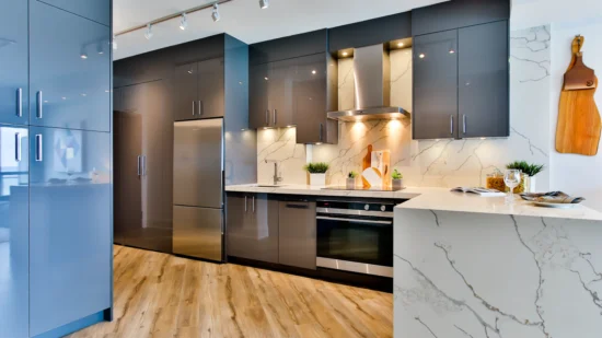 Modern modular kitchen with grey cabinets, a marble-look counter and wood-look flooring
