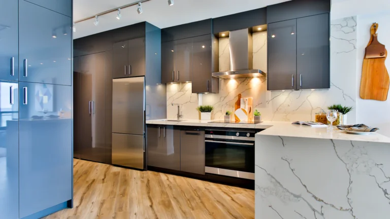 Modern modular kitchen with grey cabinets, a marble-look counter and wood-look flooring