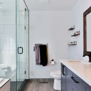 Bathroom with a glass shower enclosure, wall-mounted fittings and a vanity with a large mirror