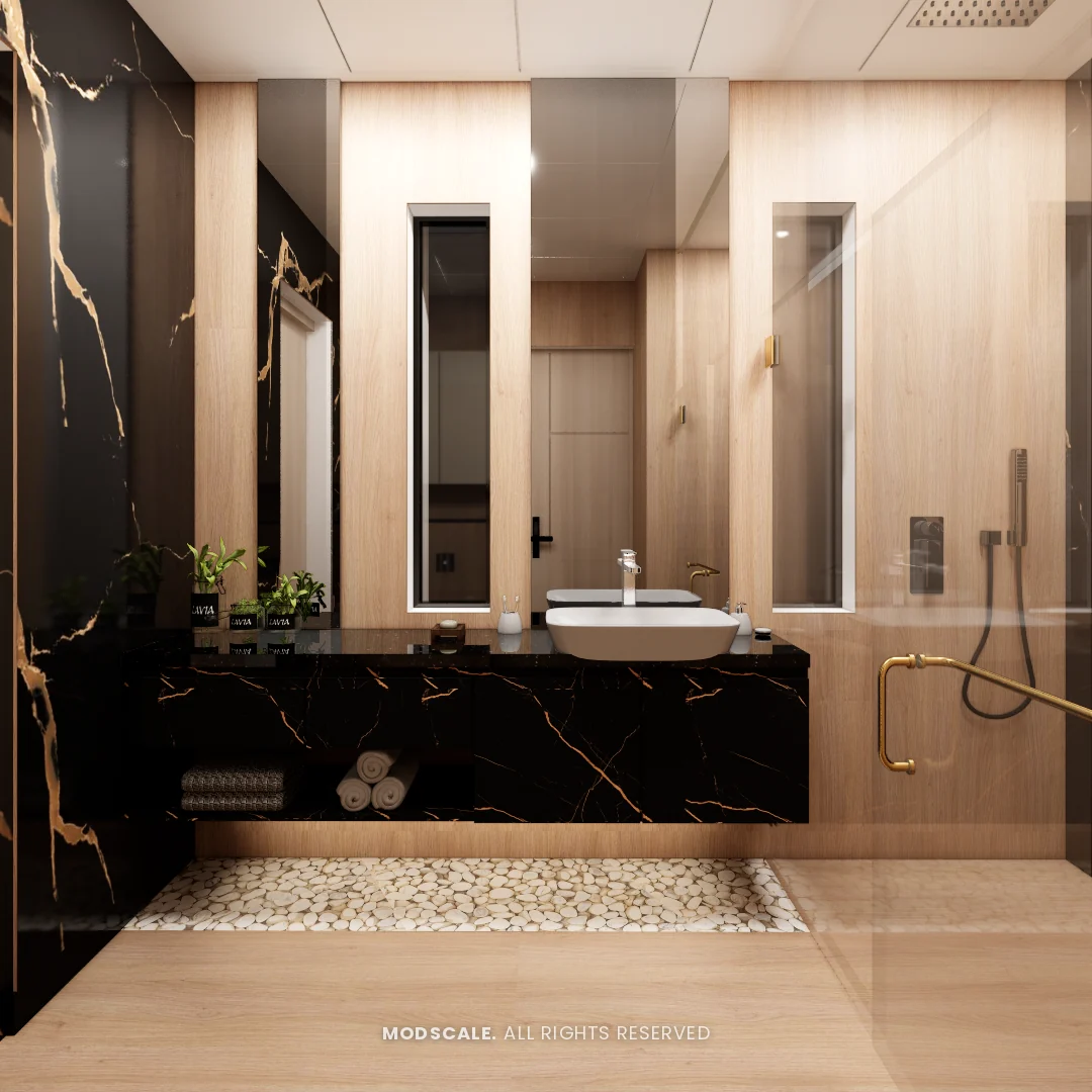 Bathroom with black and gold marble vanity, wood-look walls and pebble floor strip, Annu’s villa interior at Purva Woodfield, Chandapura, Bengaluru