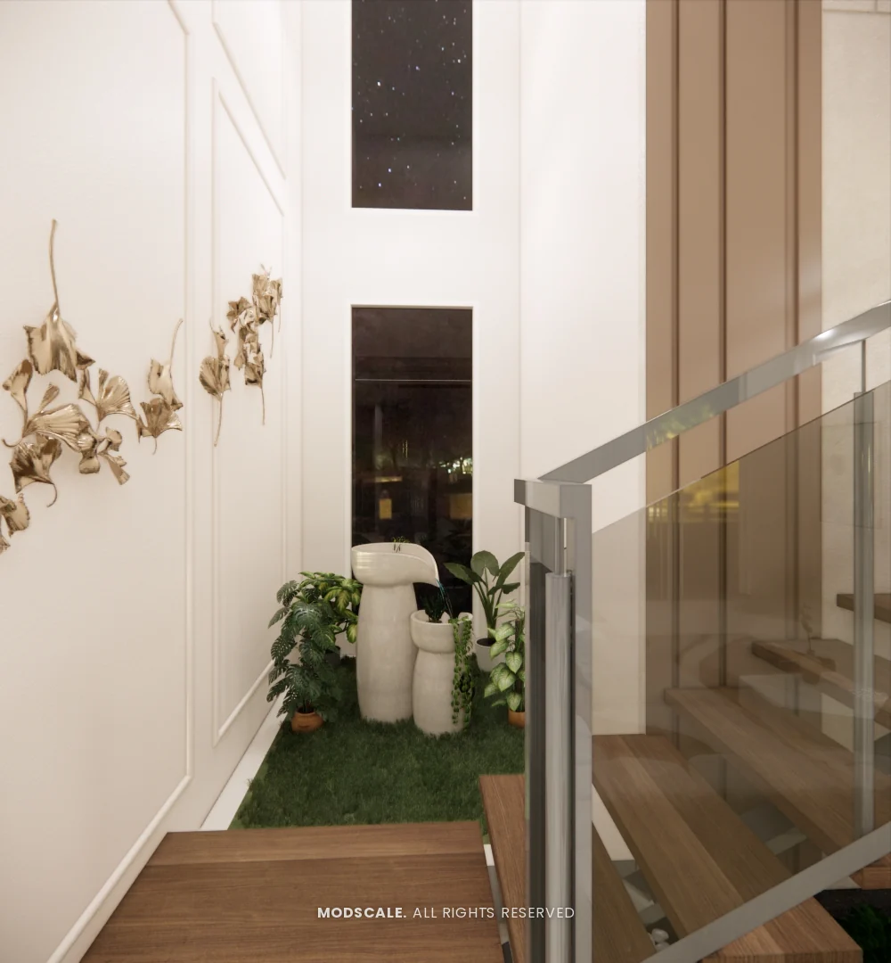 Planter bed below the staircase with brass wall art above, Mukesh’s villa interior on Sarjapur Road