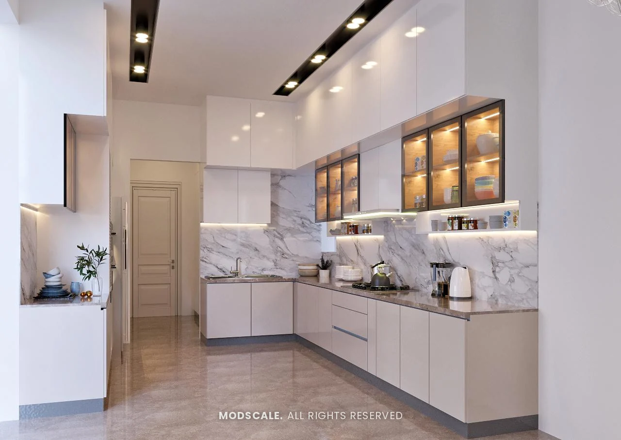 Kitchen in glossy white and beige with marble backsplash and lit glass wall cabinets, Shankar’s villa interior at Royal Meridian Layout, Begur, Bengaluru