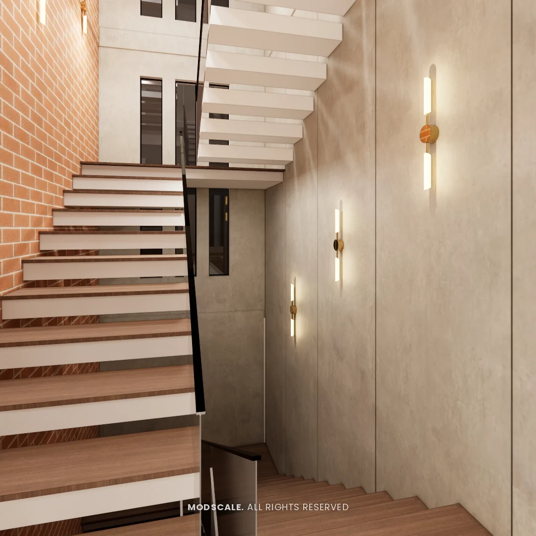 Staircase with wooden treads between an exposed brick wall and a textured wall with brass lights, Shikha Agarwal’s villa interior at Purva Woodfield, Chandapura, Bengaluru