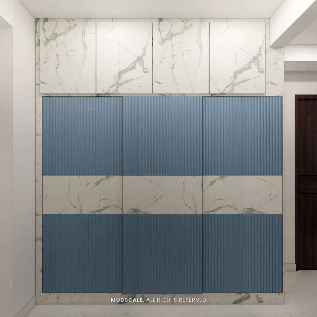 Sliding wardrobe in blue fluted finish with marble-finish band and lofts, Shikha Agarwal’s villa interior at Purva Woodfield, Chandapura, Bengaluru